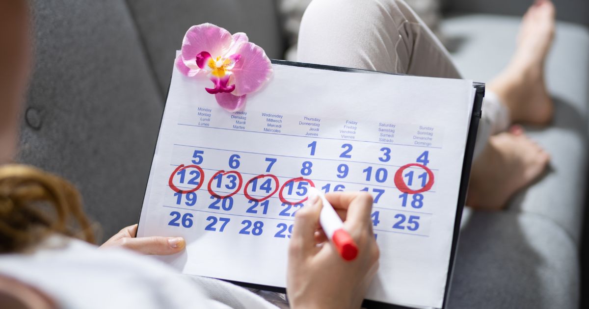 Ako privolat menstruaciu - žena si zaznamenáva dni menštruácie do kalendára červenou fixkou